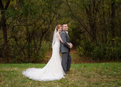 red head bride with arms around groom