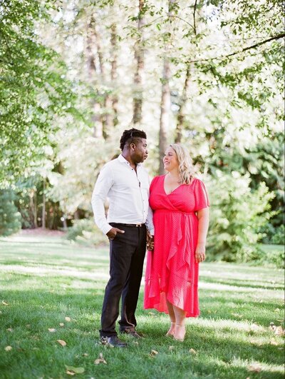 Black man and white woman engagement session posing holding hands