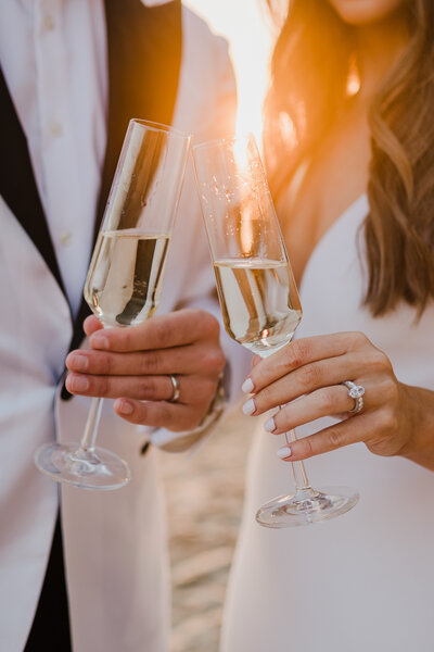 just married couple cheersing during sunset in orange county california photographed by a wedding photographer