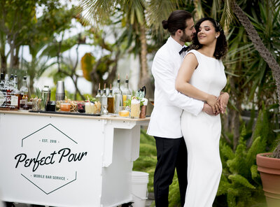 Model Couple standing next to Perfect Pour Mobile Bar Service Cart