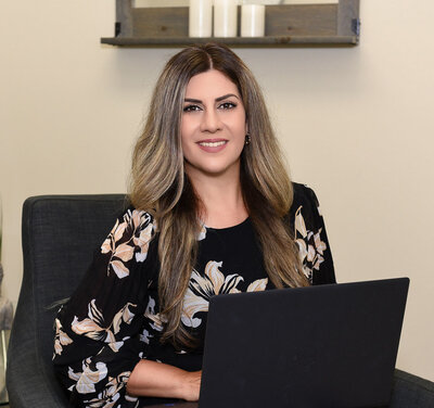 Professional headshot of a Toronto-based psychologist professional, in her office seeing patients