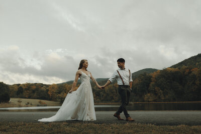 bride and groom walking up aisle while photographer takes picture eloping in the north carolina mountains at roan mountain