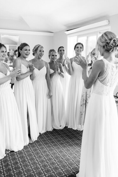 Bridesmaids smiling during the wedding dress reveal