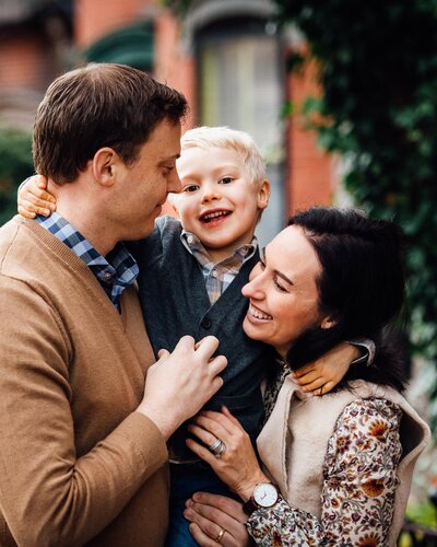 family of three embracing