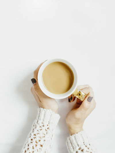 Woman holding mug of tea against white background