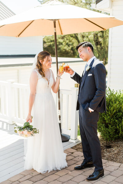 bride and groom cheers with drinks