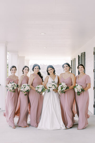 bride with bridesmaids in blush matching dresses