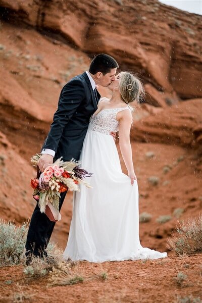 bride and groom in front of red rocks wedding
