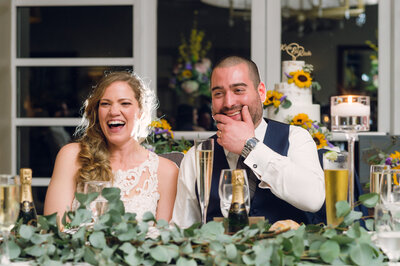 A bride and groom laughing together