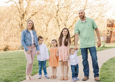 a family holding hands and walking during a family photoshoot in Pittsburgh, PA
