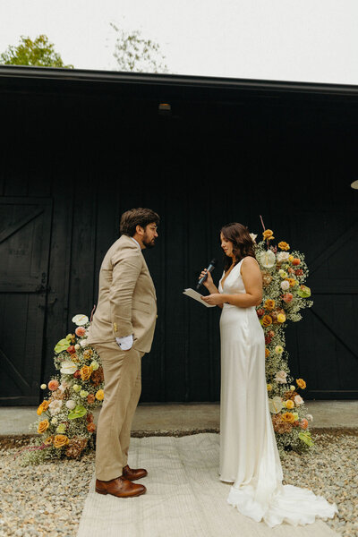 Bride reading vows during wedding ceremony - UME (New England Wedding Planner) are a wedding vendor