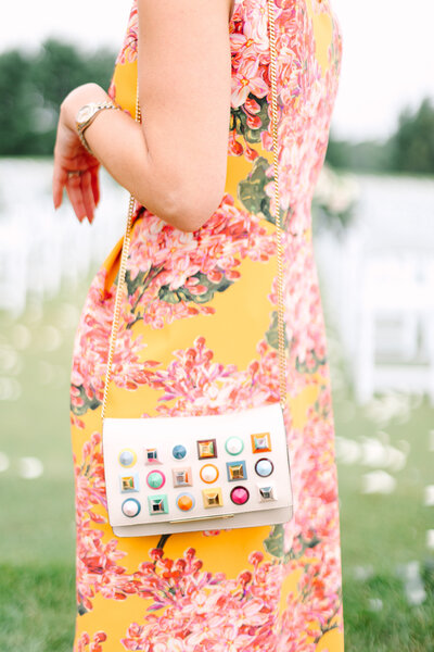 A wedding guest in a bright floral dress