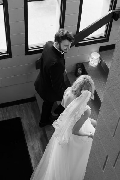 bride and groom walking up stairs at The Revel Center, a wedding venue in Grand Rapids Michigan