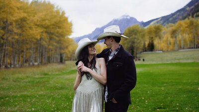 Bride and groom in front of mountains during rehearsal in Colorado