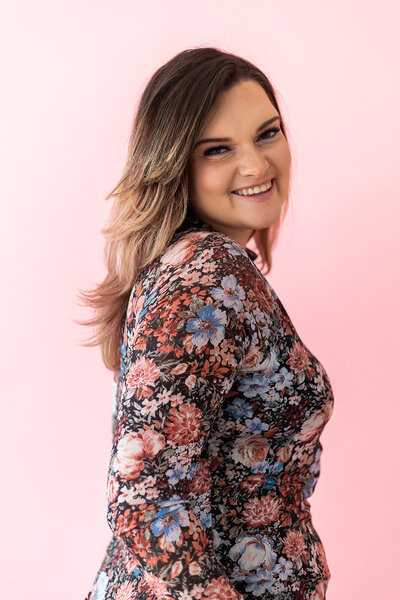 Woman Founder of Florida Social Butterfly with dark long hair in floral shirt smiling