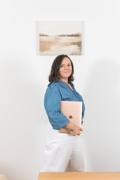 a woman sitting on a sofa looking off into the distance