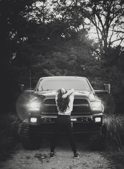 Girl and big black truck outdoor boudoir session