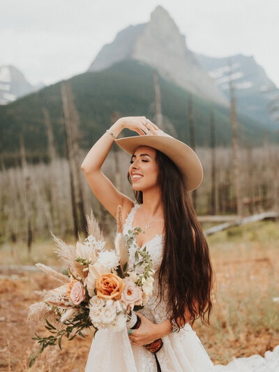 bride posing with cowboy hat