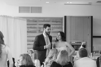 Romantic couple kiss in Downtown Market reception area – West Michigan wedding photographer.