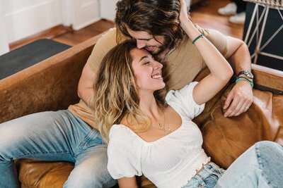 couple cuddling on the couch for couples photos