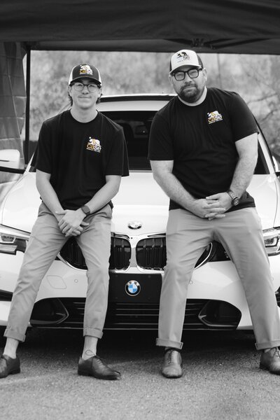 Matt and Ethan Case sitting on a  BMW that they just tinted