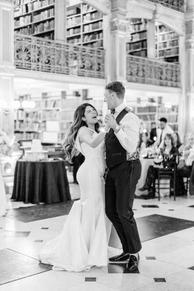 bride and groom kissing holding bouquet