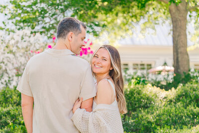 An engaged couple in a Wilmington garden in the springtime enjoying their Wilmington wedding photos by JoLynn Photography
