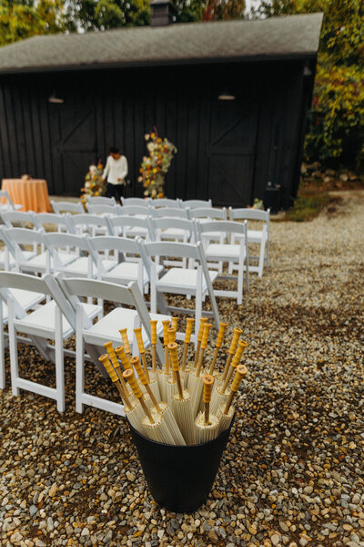 Bucket of umbrellas at wedding ceremony - UME (New England Wedding Planner)