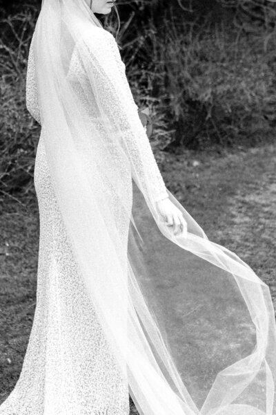 A woman in a white dress, photographed at a lake by Boston photographer Kelly Stevens.