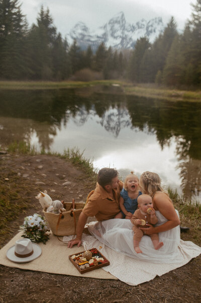 Couple enjoying a picnic with their kids during their elopement captured by Nicole Adrianna Photography