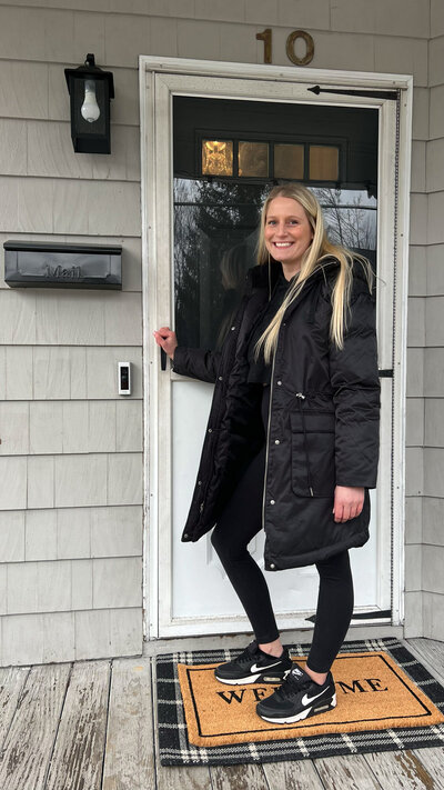 Haley standing in front of her homes front door