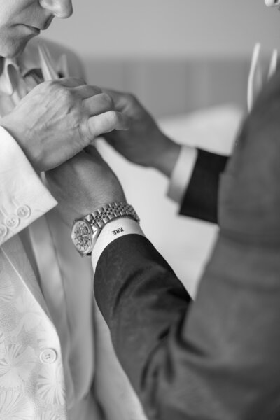 Two grooms getting ready together, Watch and monogrammed sleeve displayed.