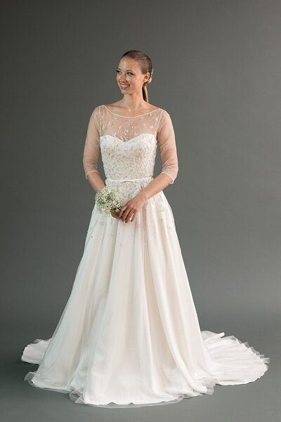 Link to more details and photos of the Rei pearl-beaded illusion-neckline wedding dress style.