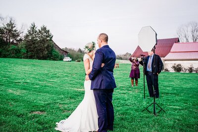 Behind the scenes photo of Ivory Door Studio working with a couple during their wedding portraits