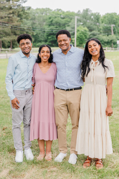 Family of 4 smiling at the camera