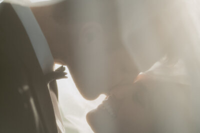 Man in Tuxedo kissing women's cheek