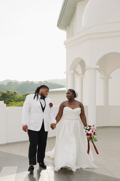 bride and groom hold hands after wedding ceremony
