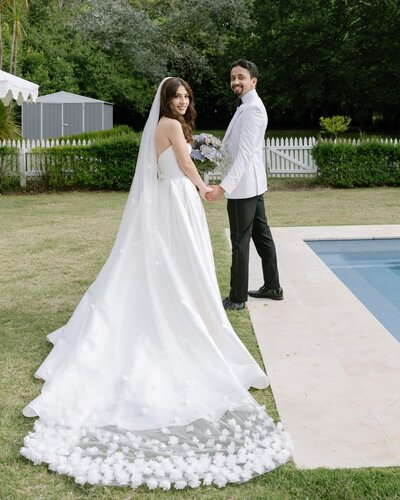 Bridal couple walking by the pool at Somerley's House