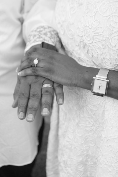 African American Woman with Wedding Ring Holding Hands with African American Man