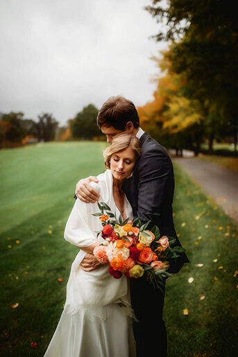 Newlyweds kiss on a hillside at their Micro Wedding  in Asheville, NC.