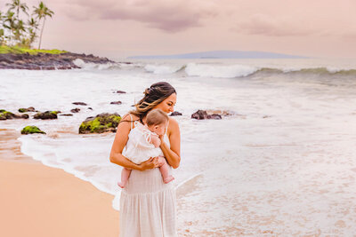 bride with newborn by the ocean in Maui