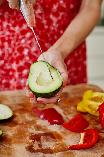 London nutritionist slicing avocado for healthy dinner