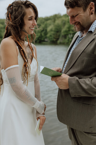 Bride and groom saying vows on a lake in Minocqua, WI. Photo taken by a Wisconsin elopement photographer