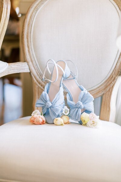 Blue shoes for the bride with stunning flowers flat lay.Blue shoes for the bride with stunning flowers flat lay.