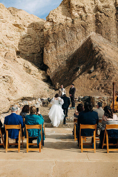 Bride and groom walking up the aisle at their outdoor Death Valley wedding ceremony