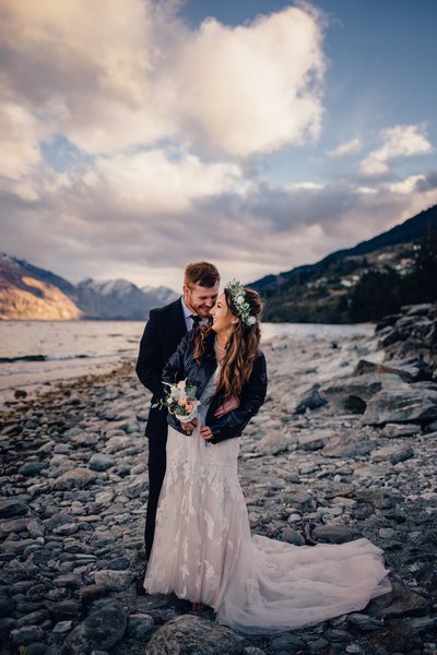 bride in leather jacket with groom on the shores of lake wakatipu