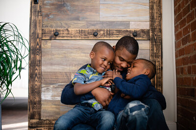 Michael T Davis, a wedding photographer in Austin, poses with his two sons