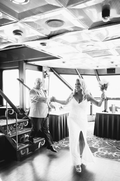 Bride and groom on Starlite Cruises yacht during Florida destination wedding with ocean and city views