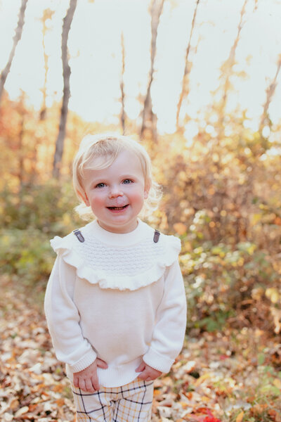 toddler girl in white sweater in nature in eagan