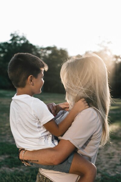 A mother cuddling with her infant. Showing the importance of working with a therapist for moms to address postpartum anxiety in Manhattan. Counseling for mothers can help whether you are trying to conceive, just had a baby, or have older kids.